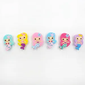 Detailed shot of six colorful mini mermaid pencil sharpeners on white background