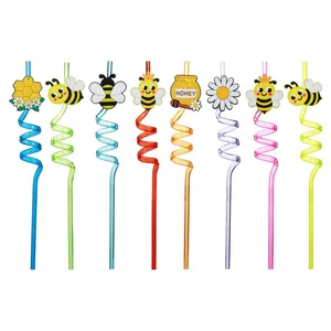 Detailed view of eight colorful spiral straws with assorted bee and honey theme charms