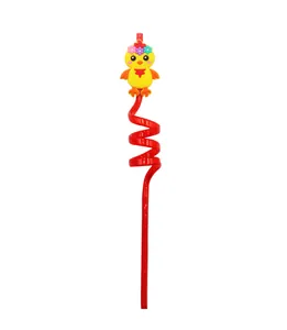 Close-up view of a red reusable spiral straw with a cute yellow cartoon chicken accessory