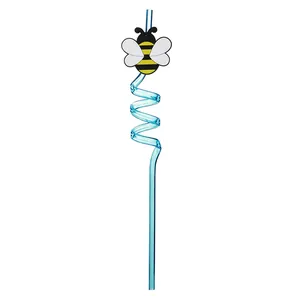 Close-up of a blue spiral drinking straw with a cute cartoon bee accessory for parties.