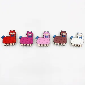 Five colorful cartoon alpaca charms in vibrant red, pink, brown, and white colors