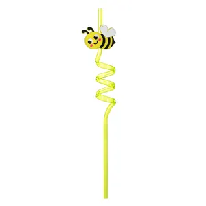 Detail view of yellow spiral reusable straw with cute cartoon bee accessory for party
