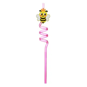 Macro view of a cute cartoon bee accessory on a pink spiral reusable drinking straw