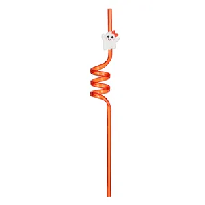 Macro view of orange curly reusable Halloween straw featuring a cute white ghost charm