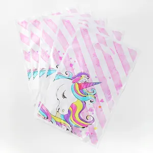 Detailed view of unicorn party gift bags featuring rainbow mane and pink striped pattern