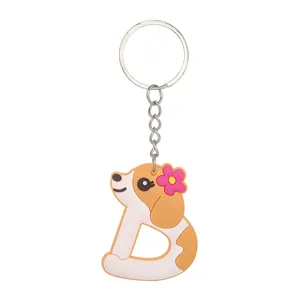 Close-up of PVC keychain featuring a puppy-shaped letter D with a pink flower.