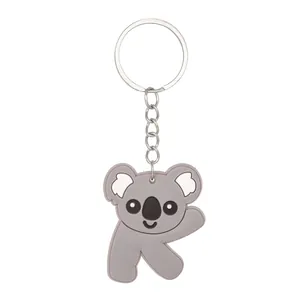 Detail of a grey PVC animal keychain shaped like the letter K with a koala design.