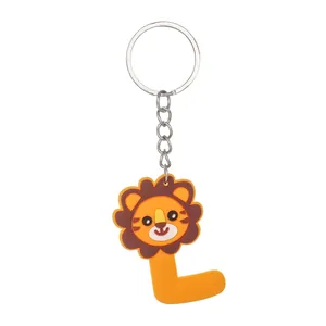 Macro view of cute cartoon lion and letter L soft PVC keychain for bag and car
