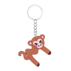 Close-up detail of a cute cartoon monkey-shaped letter M PVC keychain charm accessory