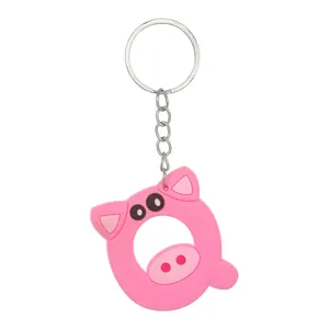Close-up detail of a cute pink PVC pig-shaped keychain designed as the letter Q for gifts