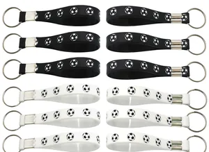 Multiple soccer silicone wristband keychains in black and white arranged neatly