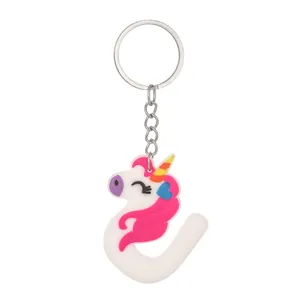 Close-up of PVC unicorn keychain integrated with letter J design on white background
