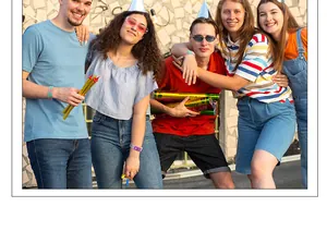 Group of young friends wearing colorful adjustable silicone party wristbands at a party