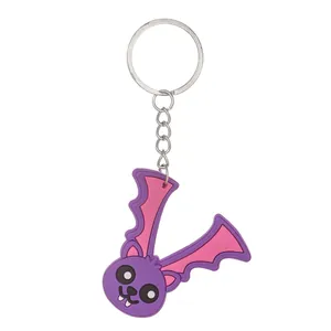 Detailed view of a purple bat-shaped letter V PVC keychain with silver metal ring
