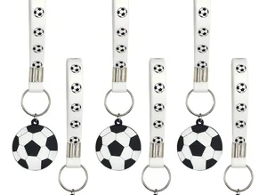 Detail of white silicone soccer keychains with black and white football patterns