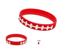 Detail view of a red silicone wristband featuring a white football stitching pattern.