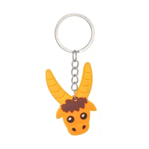 Close-up view of a cute yellow cartoon ox PVC keychain charm for party gift and car accessory