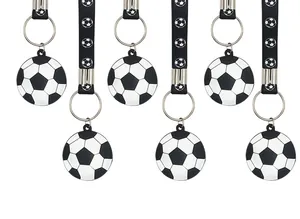 Close-up of black and white football silicone keychains for party gifts.