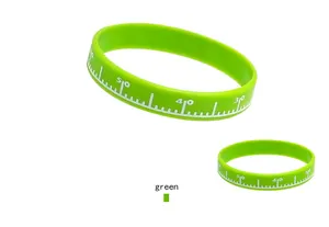 Detail view of green silicone sports bracelet featuring a unique white ruler scale pattern