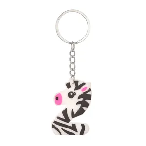 Detail of a cute cartoon zebra keychain in the shape of the letter Z made of PVC.
