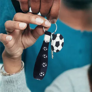 Sporty soccer themed silicone keychain featuring a black wrist strap and soccer ball charm