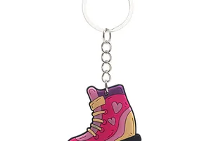 Close-up of a colorful PVC roller skate keychain with heart patterns for winter party gifts.