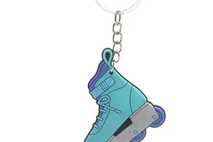 Close-up detail showing the soft PVC texture of a blue roller skate keychain pendant
