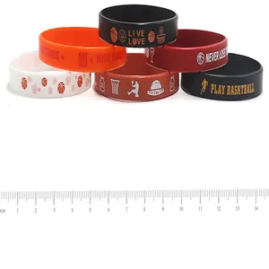 Close-up detail of basketball silicone wristbands shown with a metric measurement ruler