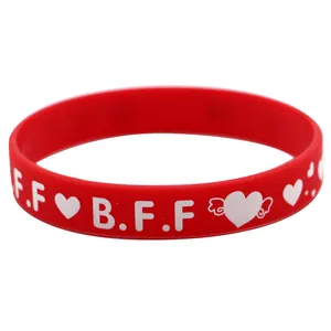 Detailansicht eines roten Silikon-BFF-Armbands mit weißen Herz- und Flügelmotiven
