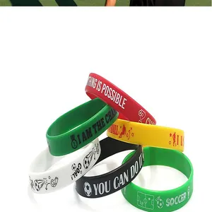 Close-up detail of colorful silicone sports wristbands featuring motivational English slogans
