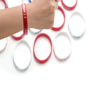 Detailed view of red softball silicone wristband featuring 'Never Give Up' printed text