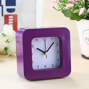 Close-up view of a purple square student alarm clock with simple white face