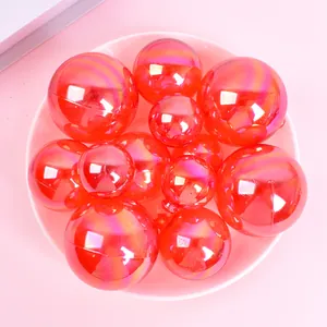 Set of iridescent red decorative balls in various sizes for festive party cake decorations