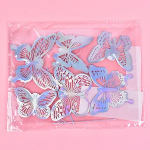 Close-up of iridescent holographic laser-cut butterfly cake toppers in clear packaging