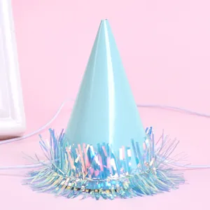 Close-up of a mini light blue pet party cone hat with iridescent tinsel fringe.