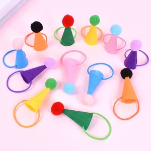 Close-up view showing a variety of colorful mini felt hats with pom-poms for small pets