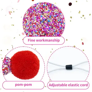 Detail showing glitter fabric, red pom-pom, and adjustable elastic cord of the pet hat