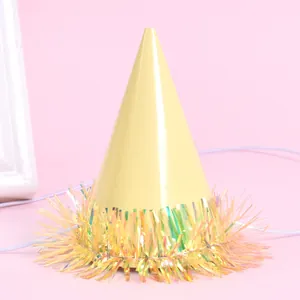Detail of a mini yellow pet party hat with iridescent fringe and elastic strap.