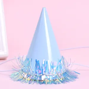 Close-up detail of light blue mini pet party hat with iridescent holographic tinsel trim