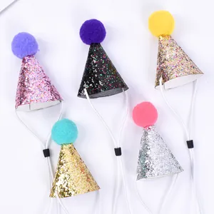 Detail view of colorful glitter pet party hats with pom-poms and adjustable straps