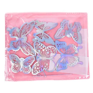 Set of 12 holographic butterfly cake toppers in clear packaging on pink background