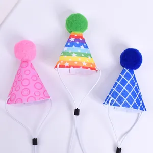 Close-up of colorful pet party hats with pompoms and adjustable straps for cats and dogs