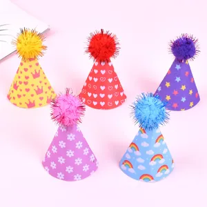 Detail of colorful felt pet birthday hats with pom-poms and various patterns.