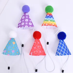 Collection of five colorful pet birthday hats with varied patterns and pom-poms