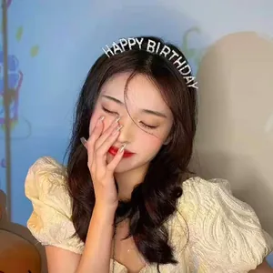 Detailed macro view of a sparkling rhinestone HAPPY BIRTHDAY headband worn by a model for parties.