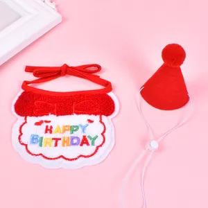 Detail view of a red and white pet birthday bib and matching pointed hat with soft textures.
