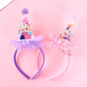 Close-up of pink and purple mesh birthday party headbands with colorful pom-poms