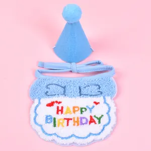 Macro detail of plush pet birthday bib and hat set featuring colorful embroidery
