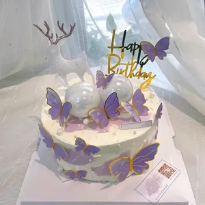 Purple butterfly cake toppers with gold edges used for elegant birthday party decorations.