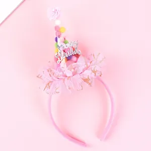 Pink birthday party headband with pom-poms and Happy Birthday tulle hat decoration